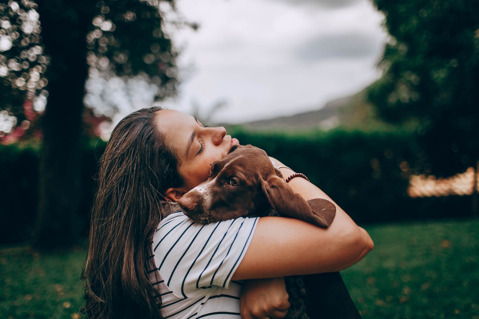 A woman embracing her newly adopted rescue dog